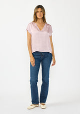[Color: Dusty Orchid] A front facing image of a brunette model wearing a pink satin top with an embroidered trim and short dolman sleeves. 