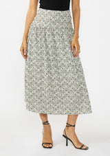 [Color: Black] A front facing image of an black and white embroidered checkered  midi skirt with a side zipper. 