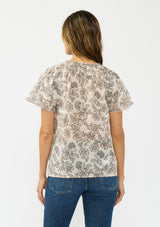 [Color: Cream/Black] A back facing image of a brunette model wearing a cotton floral top with double flutter sleeves and a split v neckline. 