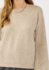 [Color: Heather Cement] A detail image of a blonde model in a beige crewneck pullover sweater with ribbed blouson sleeves. A versatile knit ideal for styling with skirts or trousers for a chic, polished outfit.