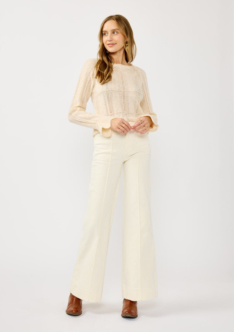 [Color: Blush] A front facing image of a blonde model wearing a fuzzy open knit pullover sweater with a crew neckline, long sleeves, and a flutter cuff. Lightweight and breezy for the fall season. 