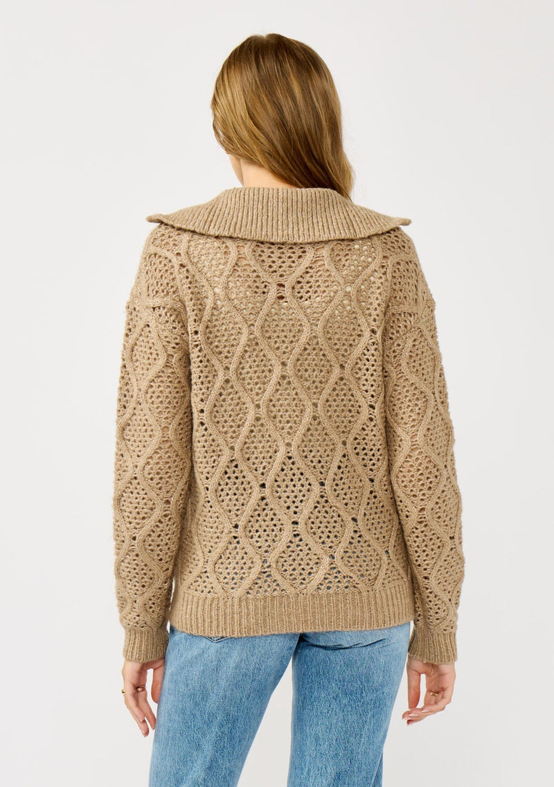 [Color: Mocha] A back facing image of a blonde model wearing a brown cable knit sweater with a full-zip front, funnel neck, and ribbed trims. A classic fall layer to pair with denim. 