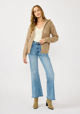 [Color: Mocha] A front facing image of a blonde model wearing a brown cable knit sweater with a full-zip front, funnel neck, and ribbed trims. A classic fall layer to pair with denim. 