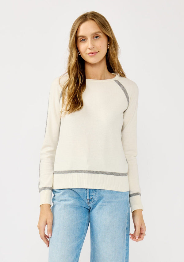 [Color: Cream/Heather Grey] A front facing image of a blonde model wearing a cream pullover sweater with a grey border stripe. Featuring long cozy sleeves, a classic crew neckline, and ribbed trimming. 