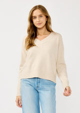 [Color: Heather Petal] A front facing image of a blonde model wearing a classic cozy v-neck pullover sweater with ribbed trims. Perfect for casual outings and the office. 