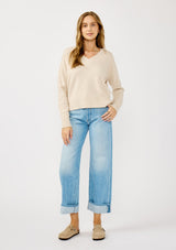 [Color: Heather Petal] A front facing image of a blonde model wearing a classic cozy v-neck pullover sweater with ribbed trims. Perfect for casual outings and the office. 