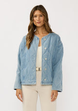 [Color: Blue] A front facing image of a brunette model wearing a blue quilted denim jacket with a button front, dropped shoulders, and side pockets. Fully lined for effortless comfort. 
