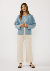 [Color: Blue] A front facing image of a brunette model wearing a blue quilted denim jacket with a button front, dropped shoulders, and side pockets. Fully lined for effortless comfort. 