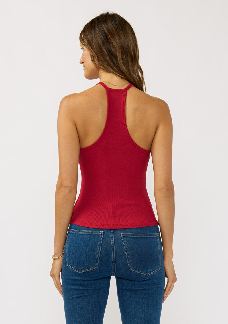 [Color: Wine Red] A back facing image of a brunette model wearing a red micro ribbed tank top with a v-neckline and racerback. A basic everyday tank top.