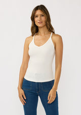[Color: White] A front facing image of a brunette model wearing a white micro ribbed tank top with a v-neckline and racerback. A basic everyday tank top.