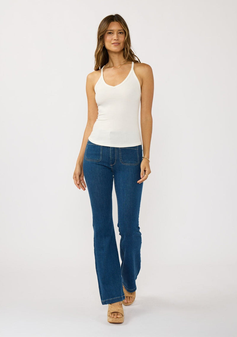 [Color: White] A front facing image of a brunette model wearing a white micro ribbed tank top with a v-neckline and racerback. A basic everyday tank top.