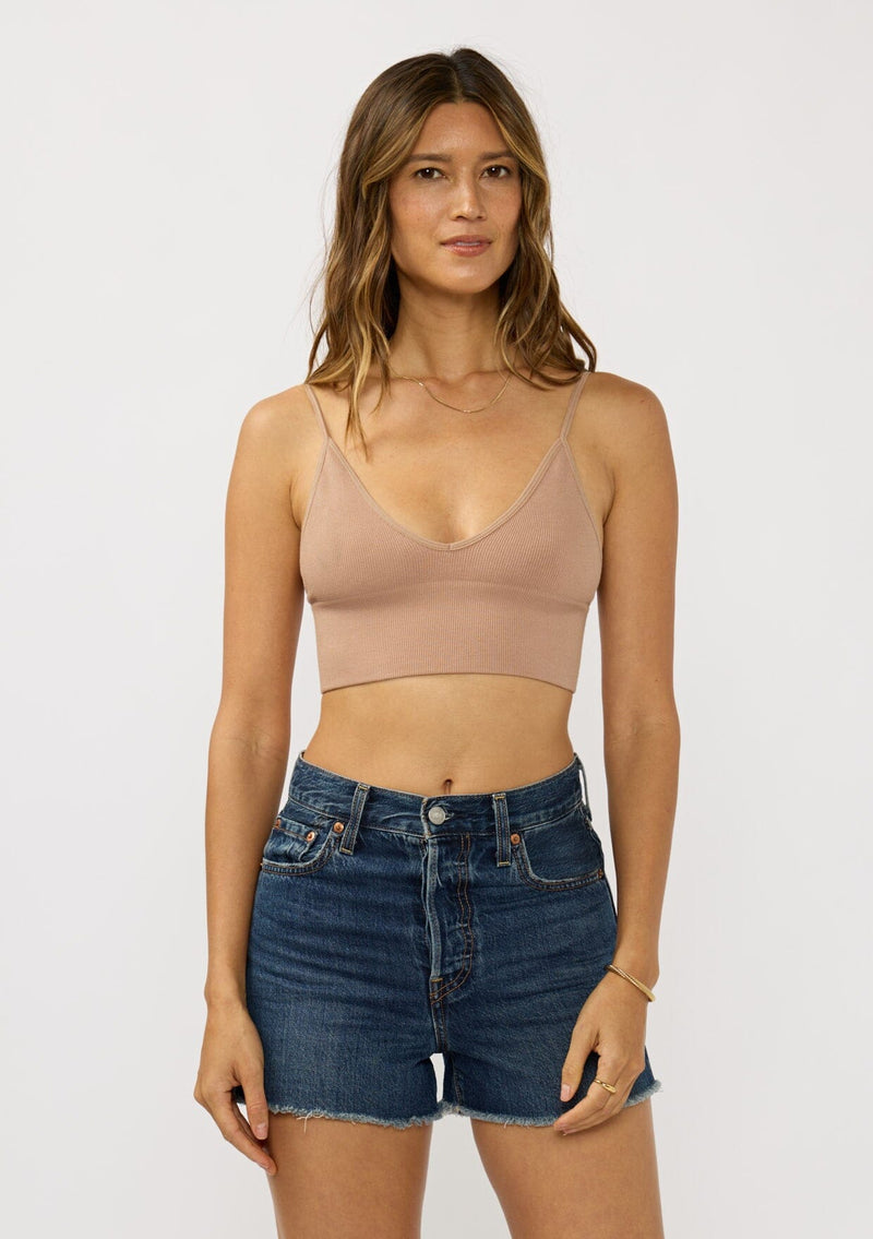 [Color: Taupe] A front facing image of a brunette model wearing a basic taupe bralette cami with a slim stretchy fit and a v-neckline.