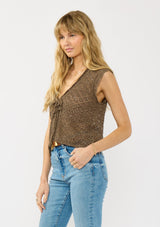 [Color: Brown] A side facing image of a blonde model wearing a brown pointelle knit vest with a tie front and sequins. 