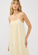 [Color: Cream] A front facing image of a blonde model wearing a flowy cutout embroidered midi dress with spaghetti straps and a back button detail. 