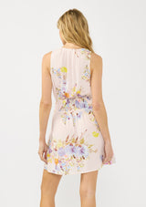 [Color: Blush/Dusty Blue] A back facing image of a blonde model wearing a pink floral mini dress with a surplice v neckline and a smocked waist at the back.
