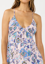[Color: Natural/Dusty Rose] A detail image of a brunette model wearing a pink and blue floral maxi with a deep v neckline, shirred bust, and spaghetti straps.