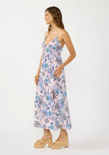 [Color: Natural/Dusty Rose] A side facing image of a brunette model wearing a pink and blue floral maxi with a deep v neckline, spaghetti straps, a cross back, and front slits. 