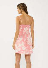 [Color: Salmon/Ivory] A back facing image of a pink floral mini dress with a sweetheart neckline, spaghetti straps, side pockets, and a smocked back. 