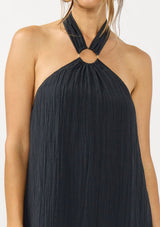 [Color: Slate Blue] A detail image of a brunette model wearing a relaxed crinkled texture maxi dress with an o ring and halter neckline. 