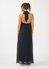 [Color: Slate Blue] A back facing image of a brunette model wearing a relaxed crinkled texture maxi dress with an o ring and halter neckline. 