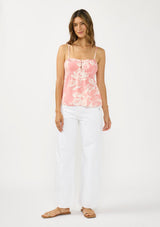 [Color: Salmon/Ivory] A front facing image of a brunette model wearing a pink and ivory cami with spaghetti straps and a button front. 