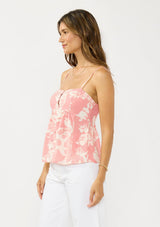 [Color: Salmon/Ivory] A side facing image of a brunette model wearing a pink and ivory cami with spaghetti straps and a button front. 