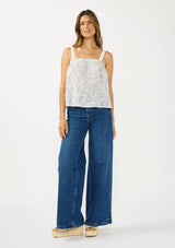 [Color: Natural/Blue] A front facing image of a brunette model wearing a blue and white bohemian tank top with a square neckline and adjustable straps with lace trim.