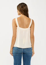 [Color: Natural/Coral] A back facing image of a brunette model wearing a coral floral tank top with solid back and a square neckline. 