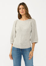 [Color: Light Heather Grey] A front facing image of a brunette model wearing a grey sweater with a crew neckline and three quarter length sleeves. 