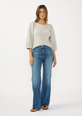 [Color: Light Heather Grey] A front facing image of a brunette model wearing a grey sweater with a crew neckline and three quarter length sleeves. Tucked into a light wash denim. 