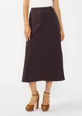 [Color: Chocolate] A front facing image of a brunette model wearing a brown ribbed knit maxi skirt with an elastic waistband. 
