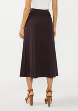 [Color: Chocolate] A back facing image of a brunette model wearing a brown ribbed knit maxi skirt with an elastic waistband. 