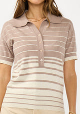 [Color: Fawn/Stone] A detail image of a brunette model wearing a beige collared sweater top with a striped design, a button front, and short sleeves. 
