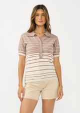 [Color: Fawn/Stone] A front facing image of a brunette model wearing a beige collared sweater top with a striped design, a button front, and short sleeves. 