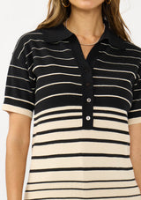 [Color: Black/Buttercream] A detail image of a brunette model wearing a black and beige collared sweater top with a striped design, a button front, and short sleeves. 