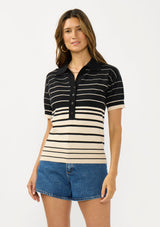[Color: Black/Buttercream] A front facing image of a brunette model wearing a black and beige collared sweater top with a striped design, a button front, and short sleeves. 