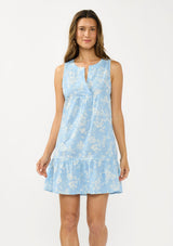 [Color: Blue/Ivory] A front facing image of a brunette model wearing a blue floral sleeveless mini dress with a split v neckline and side pockets.  