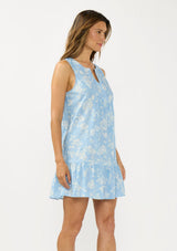 [Color: Blue/Ivory] A side facing image of a brunette model wearing a blue floral sleeveless mini dress with a split v neckline and side pockets.  