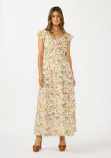 [Color: Blush/Rose] A front facing image of a brunette model wearing a pink and green floral maxi dress with a ruffled top, v neckline, elastic waist, and a tiered skirt with a slit. 