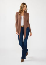 [Color: Clove] A front facing image of a Lovestitch model wearing a chic brown waffle knit wrap front sweater with long sleeves, a v neckline, and a button closure at the back. The long ties can be styled in multiple ways.