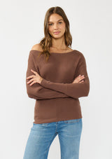 [Color: Clove] A front facing image of a brunette model wearing a brown waffle knit pullover sweater. With long sleeves, a relaxed fit, and a wide neckline that can be worn off the shoulder.