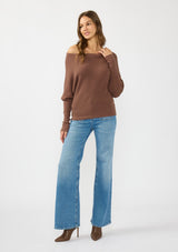 [Color: Clove] A front facing image of a brunette model wearing a brown waffle knit pullover sweater. With long sleeves, a relaxed fit, and a wide neckline that can be worn off the shoulder.