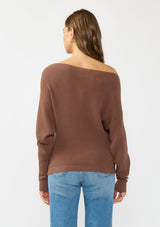 [Color: Clove] A back facing image of a brunette model wearing a brown waffle knit pullover sweater. With long sleeves, a relaxed fit, and a wide neckline that can be worn off the shoulder.
