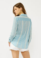 [Color: Light Blue/Ivory] A back facing image of a blonde model wearing a light blue shirt with an embroidered stripe pattern,  a classic collar neckline, and button front. A boho inspired shirt for festivals, casual outings, and country events. 