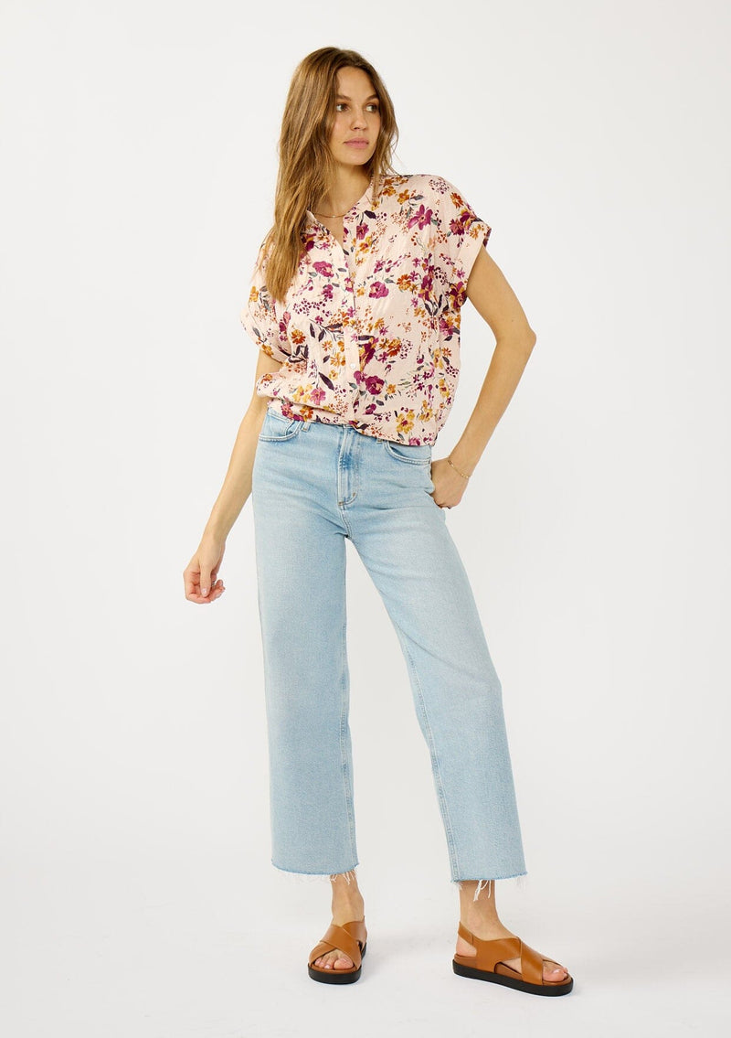 [Color: Almond/Wine] A front facing image of a blonde model wearing a pink floral print top with a button front, twist front detail, and short dolman sleeves. 