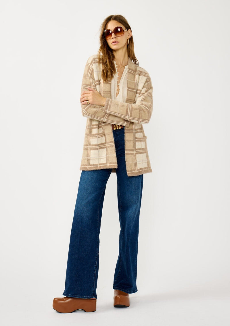 [Color: Tan/Mocha] A front facing image of a blonde model wearing a brown plaid cardigan with cozy long sleeves and an open front. A warm fuzzy sweater for the fall season. 