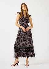 [Color: Black/Pink] A front facing image of a blonde model wearing a black and pink floral print maxi dress with flutter cap sleeves, a v-neckline, button front, smocked back, and sheer tiered layers. A special occasion dress for the fall season. 