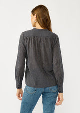 [Color: Navy/Taupe] A back facing image of a blonde model wearing a dark navy checkered blouse with a round neckline, button front, and center front pintuck details. A casual fall piece with a polished touch for work and casual outings. 