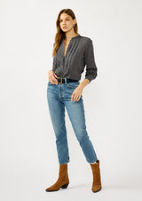 [Color: Navy/Taupe] A front facing image of a blonde model wearing a dark navy checkered blouse with a round neckline, button front, and center front pintuck details. A casual fall piece with a polished touch for work and casual outings. 