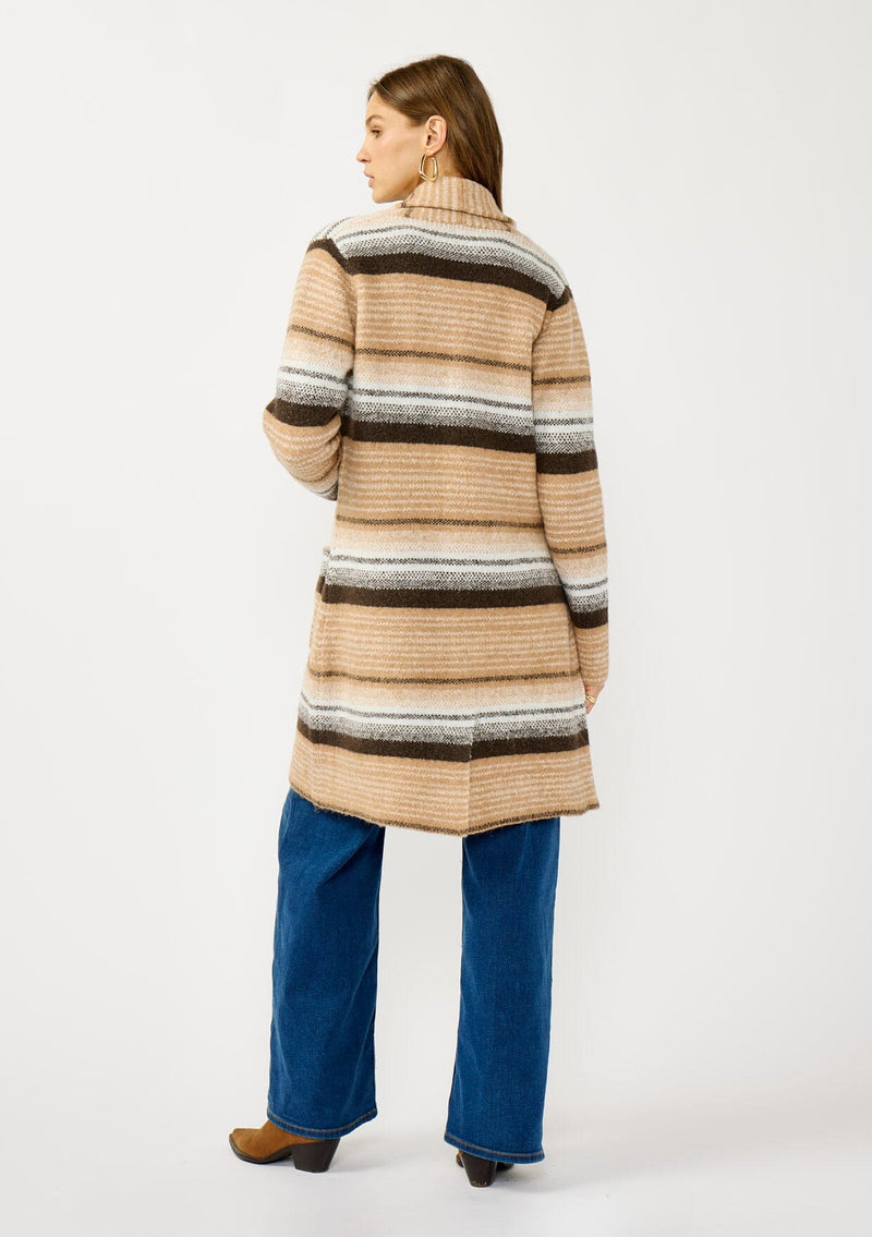[Color: Camel/Brown] A back facing image of a blonde model wearing a brown and tan striped mid length coatigan with a shawl collar, button front, and side patch pockets. Effortlessly cozy for the fall and winter season. 